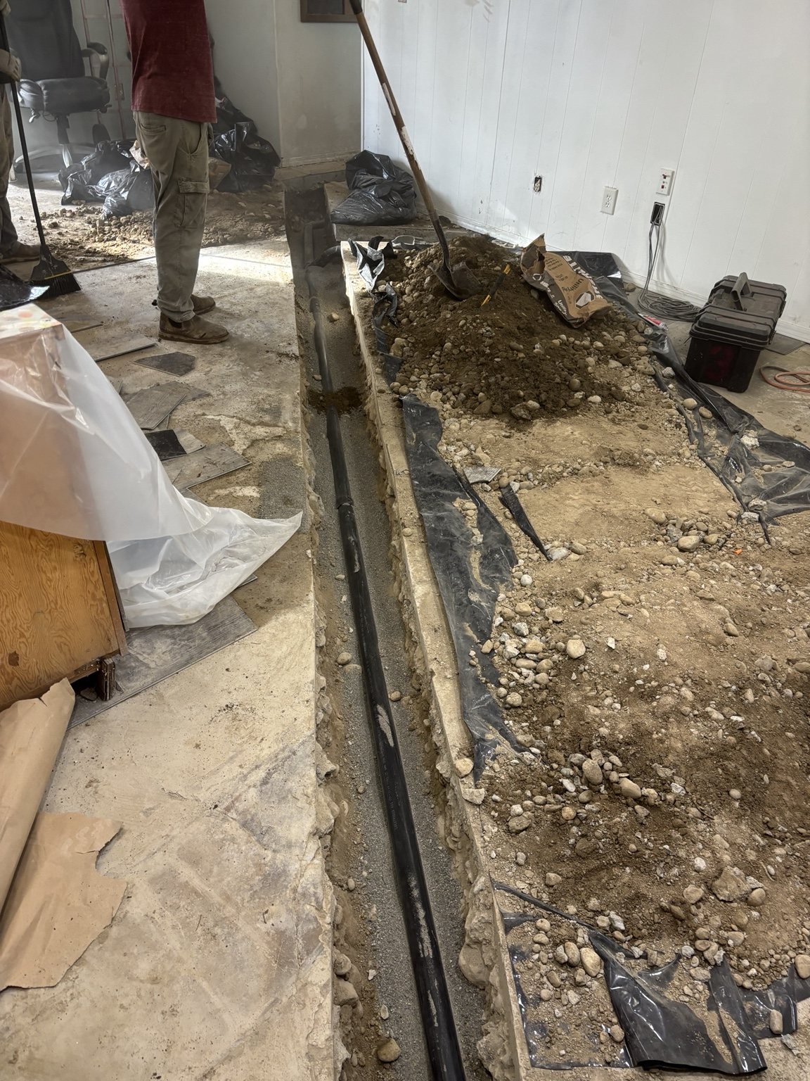 Interior underground drain line excavation by Right Direction Plumbing